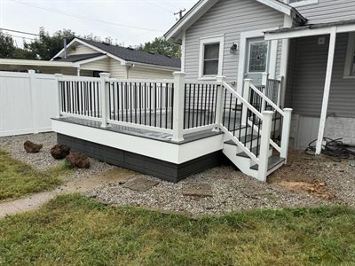Low composite deck with white railing and black balusters on a Shively KY home