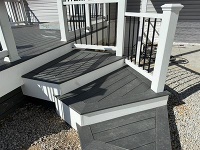 Composite step with contrasting border and inlaid board pattern in Shively