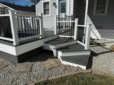 Two-tone gray composite deck and corner steps on a Shively home