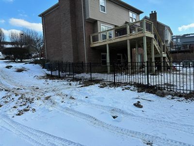 Second-story deck built in winter behind a brick home in Fern Creek