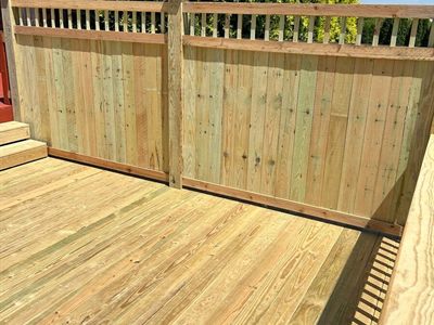 Treated wood deck with a solid privacy wall in Crestwood KY