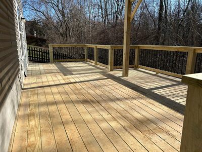 Wide treated wood deck surface backing to woods in Fern Creek KY