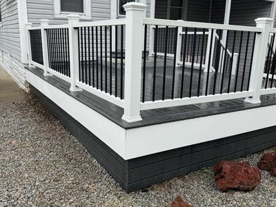 Composite deck with white fascia and dark gray skirting in Shively