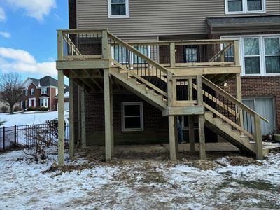 Raised deck with switchback stairs on a Fern Creek home