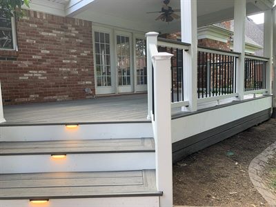 Gray composite deck under a covered porch with white railing in Crestwood KY