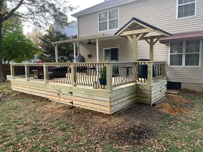 Low deck with horizontal board skirting off a covered patio in PRP