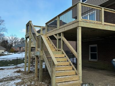 Tall treated wood deck with a long stair run and landing in Fern Creek KY